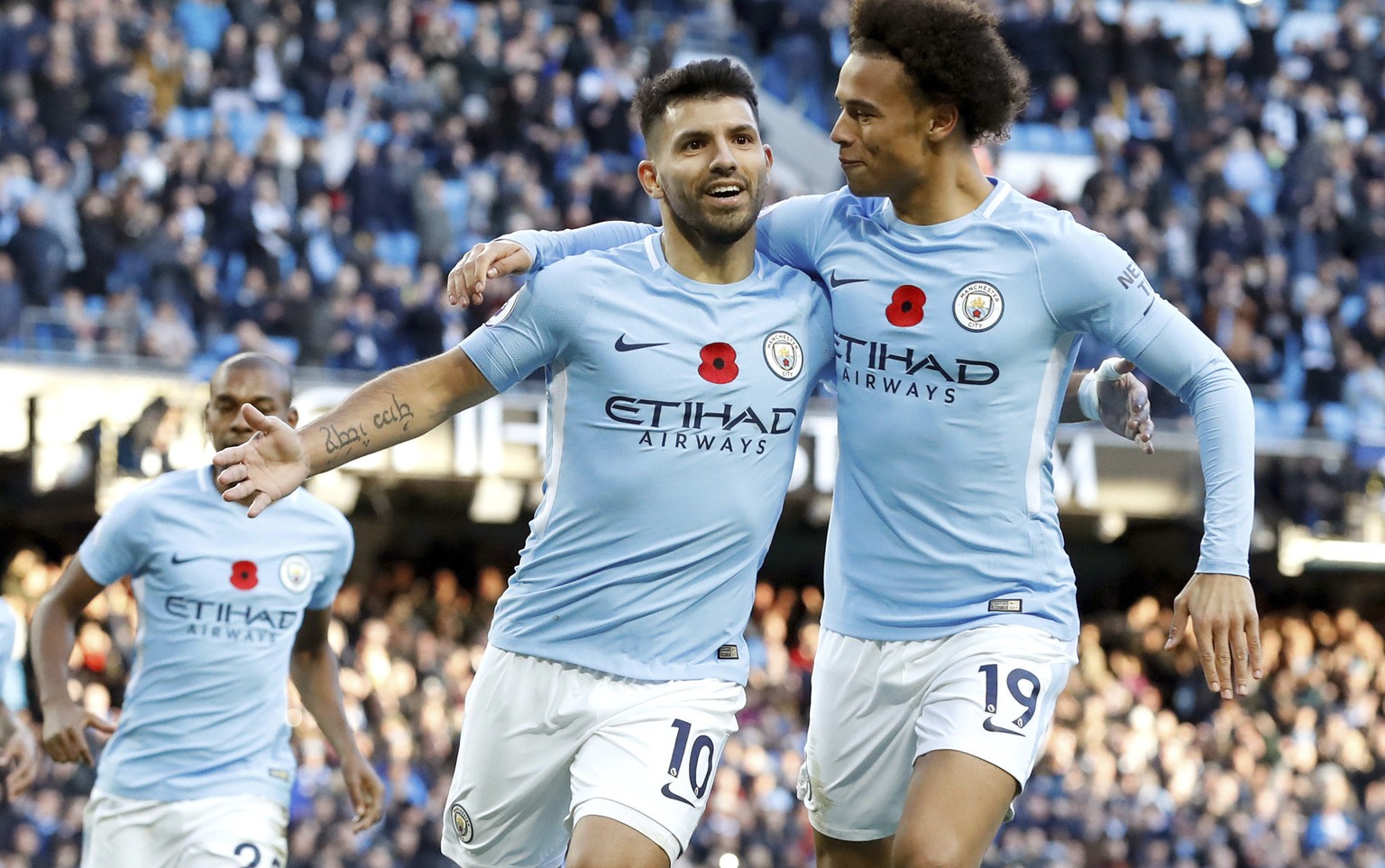Manchester City&#039;s Sergio Aguero, left, celebrates scoring his side&#039;s second goal of the game during the English Premier League soccer match between Manchester City and Arsenal, at the Etihad ...