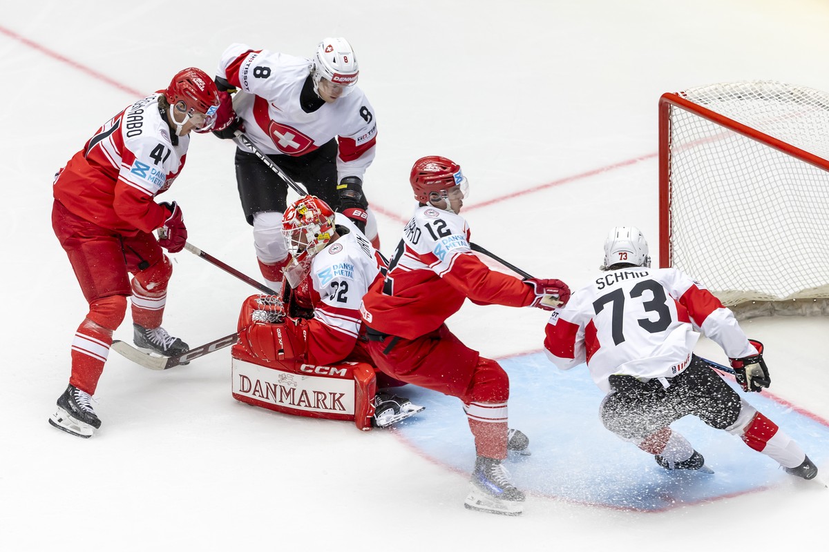 Denmark's goaltender Sebastian Dahm, block the puck past Denmark's defender Jesper Jensen Aabo #41,Switzerland's forward Simon Knak #8, Denmark's forward Oscar Moelgaard #12, and S ...