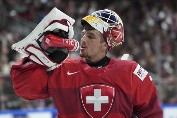 Goalie Joren Pottelberghe of Switzerland drinks during the group B match between Latvia and Switzerland at the ice hockey world championship in Riga, Latvia, Tuesday, May 23, 2023. (AP Photo/Roman Kok ...