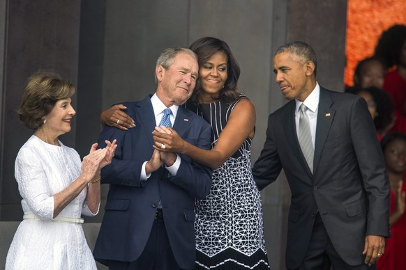 epa05706681 (FILE) - A file picture dated 24 September 2016 shows US First Lady Michelle Obama (C-R) as she hugs former President George W. Bush (C-L) while President Barack Obama (R) and former First ...
