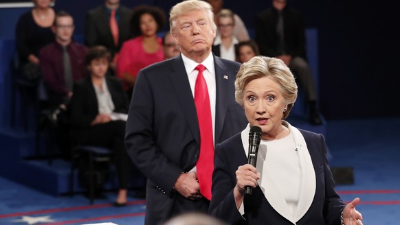 FILE - In this Oct. 9, 2016 file photo, Democratic presidential nominee Hillary Clinton, right, speaks as Republican presidential nominee Donald Trump listens during the second presidential debate at  ...
