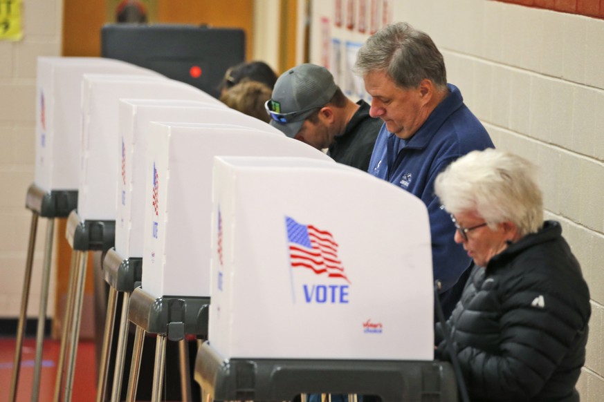 Voters caste their ballots at a polling station in Richmond, Va., Tuesday, Nov. 5, 2019. All seats in the Virginia House of Delegates and State senate are up for election. (AP Photo/Steve Helber)