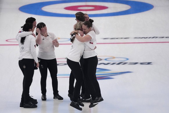 Britain's athletes celebrate after winning the women's curling final against Japan at the Beijing Winter Olympics Sunday, Feb. 20, 2022, in Beijing. (AP Photo/Nariman El-Mofty)