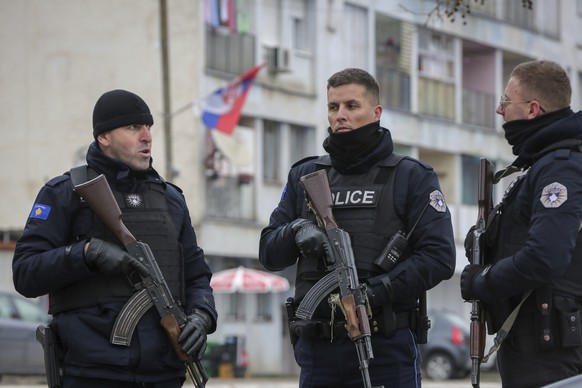 Kosovo police officers patrol a mixed neighborhood in the ethnically divided town of Mitrovica, in northern Kosovo.  12, 2022. Barricades erected by local Serbs in the north of…
