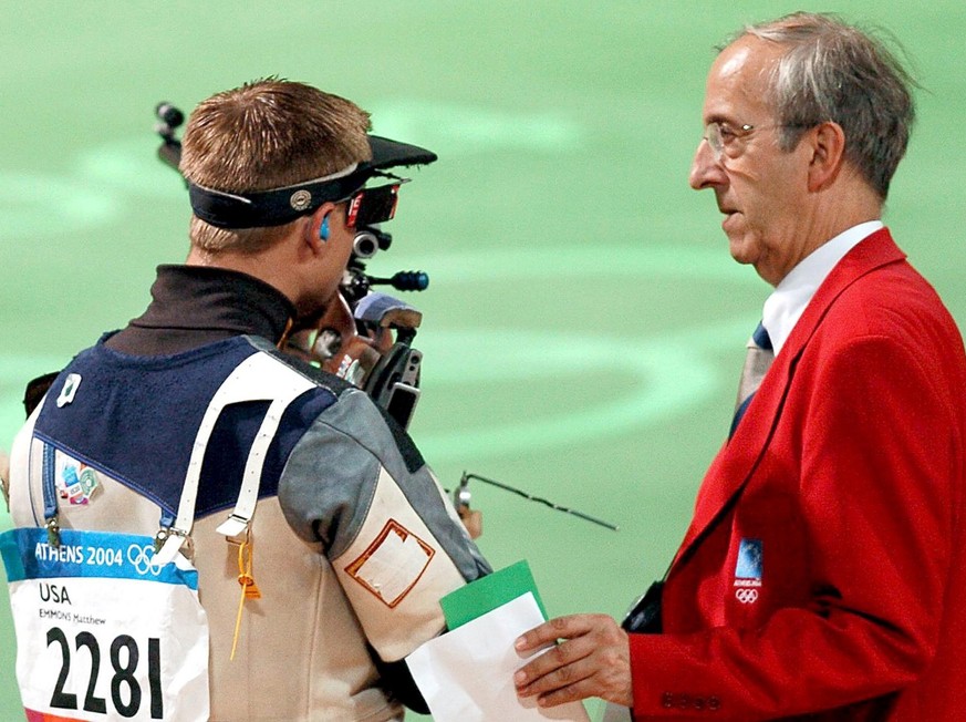 US shooter Matthew Emmons (L) talks to an official (R) during the men&#039;s 50m Rifle 3 Positions event of the Athens 2004 Olympic Games at the Markopoulo Shooting Centre, Sunday 22 August 2004. Matt ...