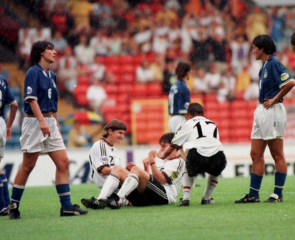 Germany - Italy (2-0) Birgit Prinz is embraced by teammates Kerstin Stegmann (2) and Ariane Hingst (17) after scoring Germany s second goal in the match against Italy during today s final of the women ...