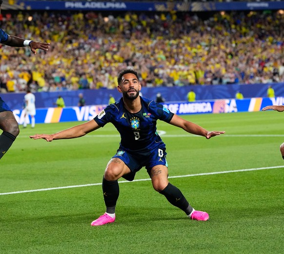 Brazil's Matheus Cunha (9) celebrates after scoring his side's second goal with Brazil's Vinicius Junior (7) and Lucas Paqueta (20) during the World Cup Group C soccer match between Bra ...