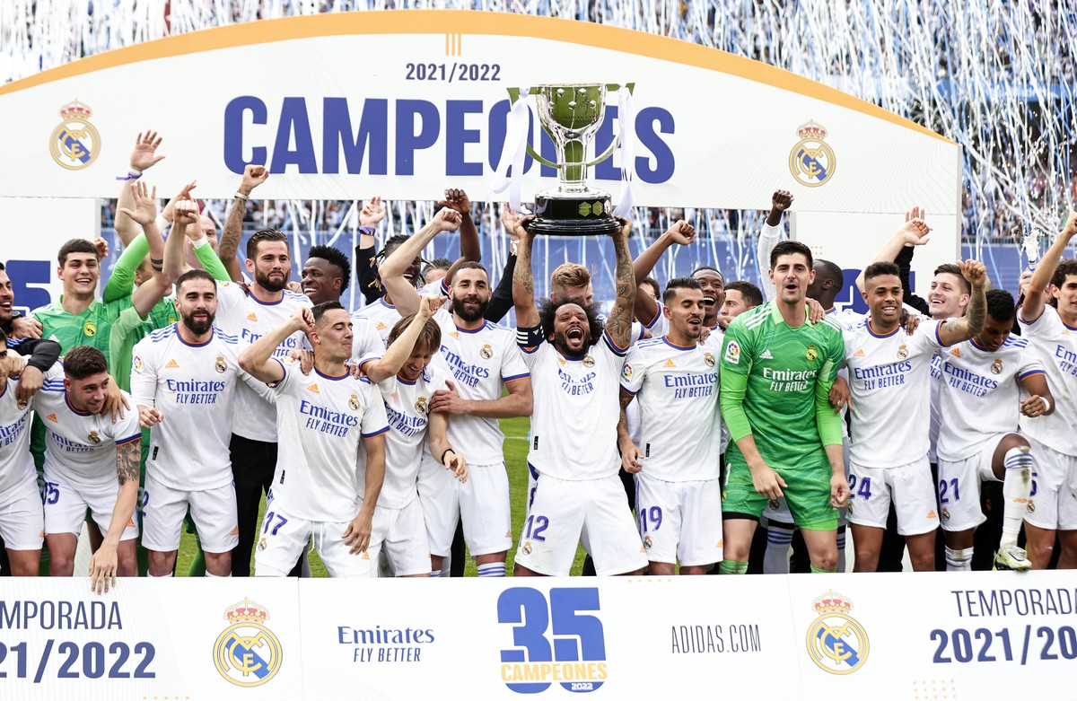 In this photo provided by the Spanish Royal Football Federation, Real Madrid player Marcelo lifts the trophy celebrating the team's La Liga title after a Spanish La Liga soccer match between Real ...