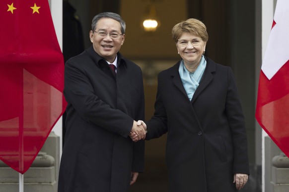 Swiss President Viola Amherd, right, and Chinese Prime Minister Li Qiang shake hands during their meeting in Kehrsatz, near Bern, Switzerland, Monday, Jan. 15, 2024. Chinese Prime Minister Li Qiang is ...