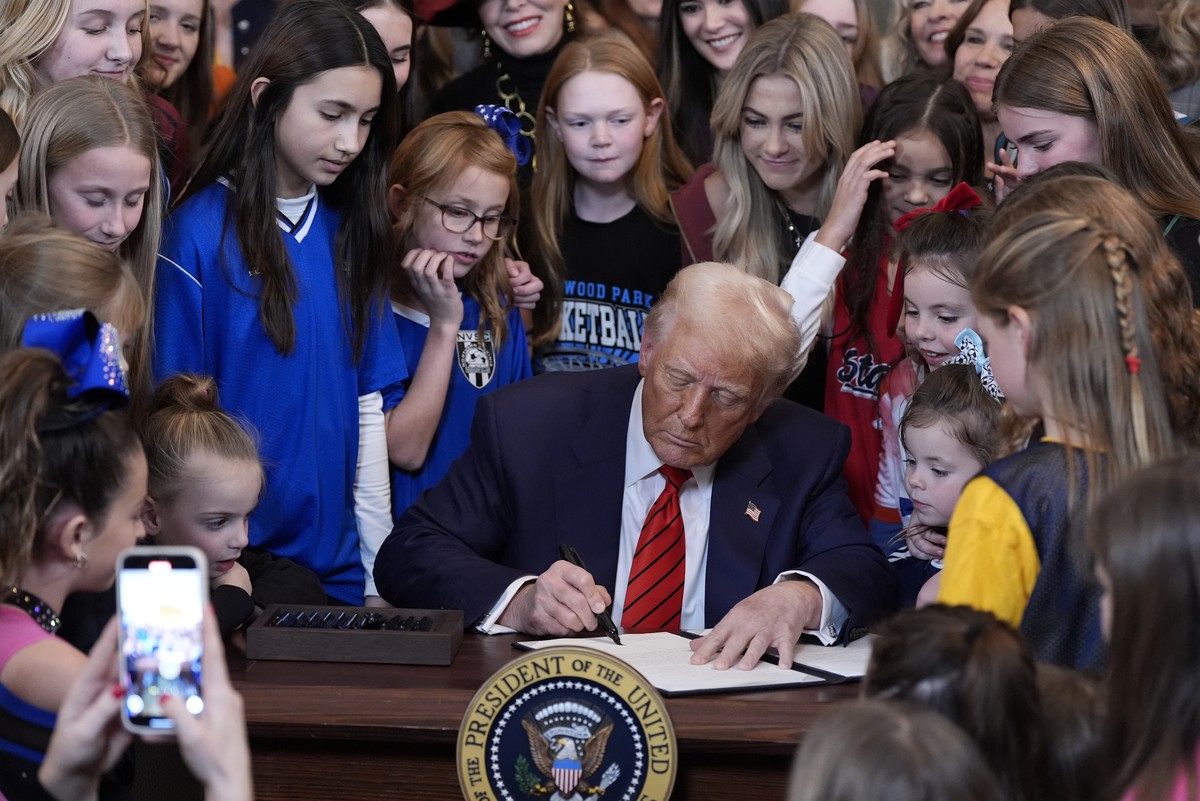 FILE - President Donald Trump signs an executive order barring transgender female athletes from competing in women's or girls' sporting events, in the East Room of the White House, Feb. 5, 2 ...