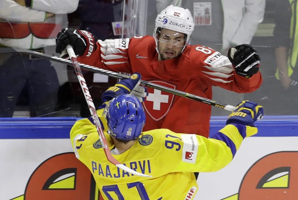 Switzerland&#039;s Simon Moser, above, challenges for the puck with Sweden&#039;s Magnus Paajarvi during the Ice Hockey World Championships final match between Sweden and Switzerland at the Royal aren ...