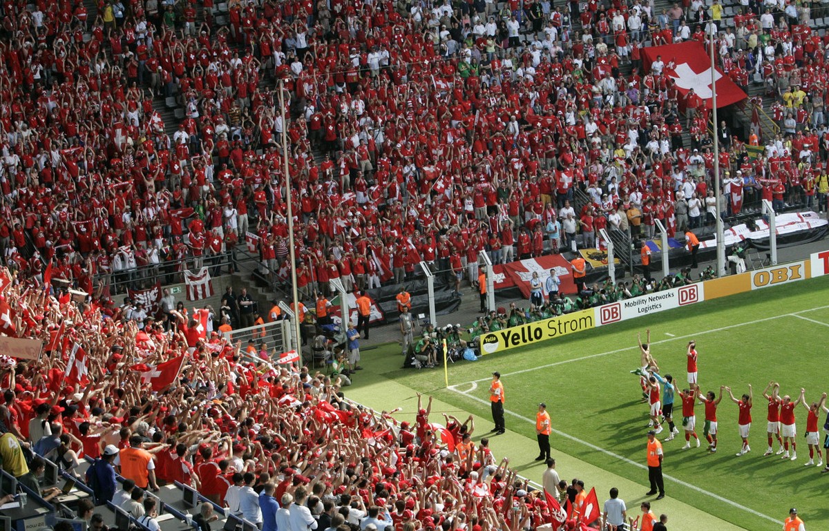 Switzerland's players celebrate with their fans after the Germany 2006 Soccer World Cup, Group G, soccer match between Togo and Switzerland at Dortmund's stadium, Germany, Monday, June 19, 2 ...