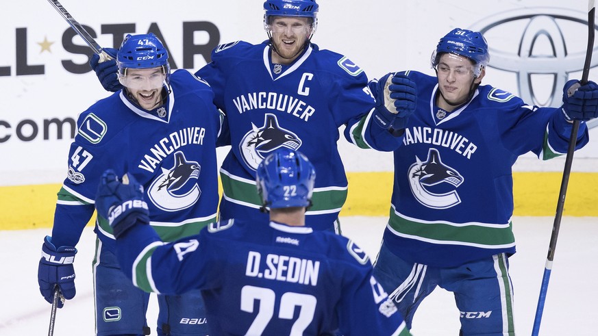 Vancouver Canucks&#039; Sven Baertschi, from top left, Henrik Sedin, of Sweden, Troy Stecher and Daniel Sedin, bottom, of Sweden, celebrate Baertschi&#039;s second goal against the Colorado Avalanche  ...