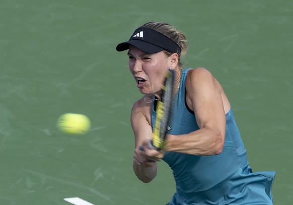 Caroline Wozniacki, of Denmark, hits a return to Marketa Vondrousova, of the Czech Republic, during the National Bank Open women?s tennis tournament Wednesday, Aug. 9, 2023, in Montreal. (Christinne M ...