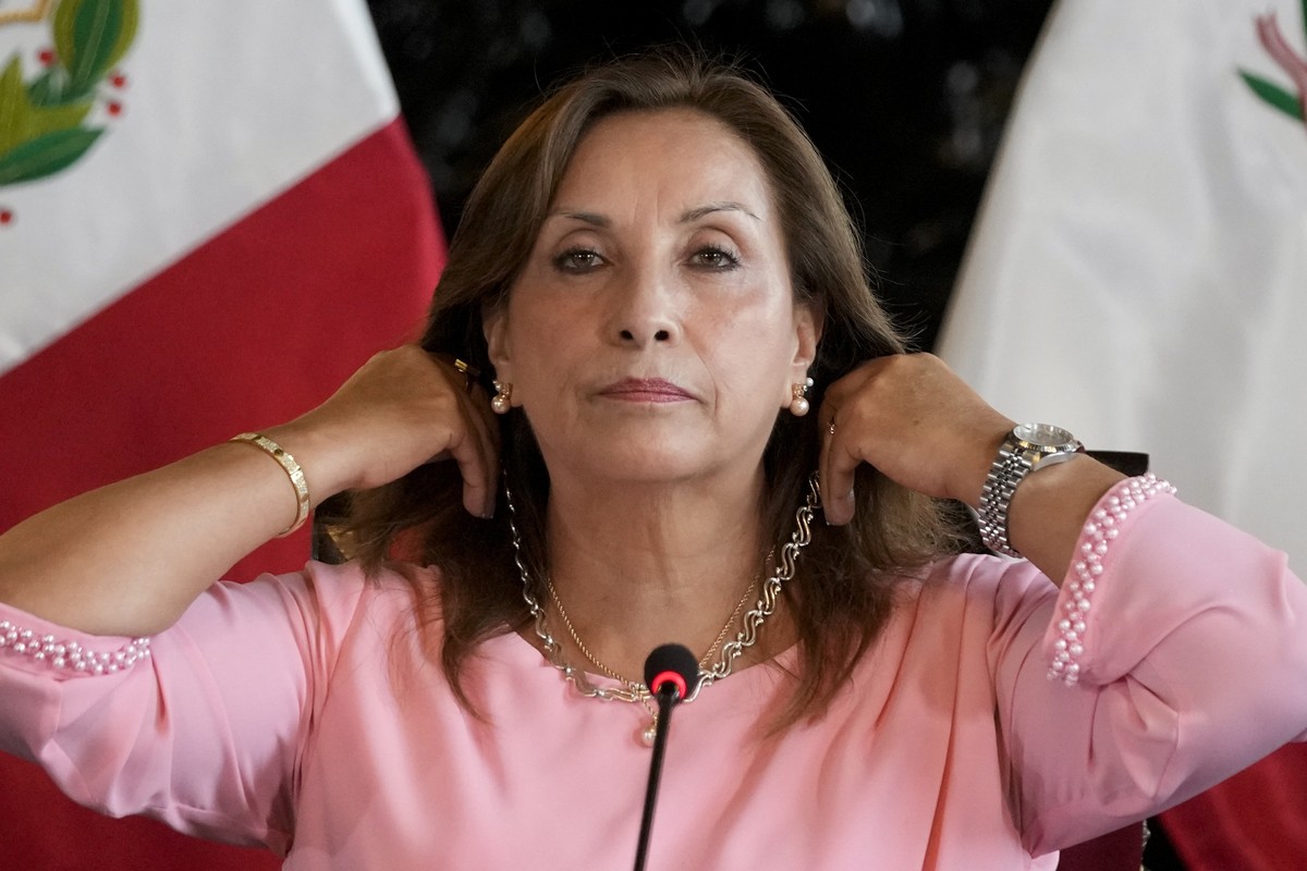 Peru's President Dina Boluarte shows her jewelry during a press conference at Government Palace in Lima, Peru, Friday, April 5, 2024. Authorities are investigating on whether she illegally receiv ...