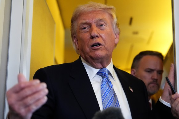 President Donald Trump speaks to reporters aboard Air Force One, Friday, May 15, 2026, as he returns from a trip to Beijing, China. (AP Photo/Mark Schiefelbein)
Donald Trump