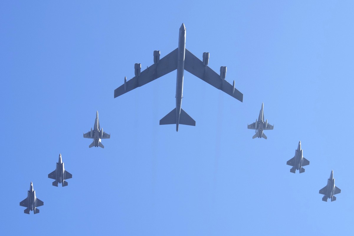 A B52 bomber, centre, accompanied by F35 jets and F18 jets flies over the city center during celebrations of the 107th anniversary of the Republic of Estonia, in Tallinn, Estonia, Monday, Feb. 24, 202 ...