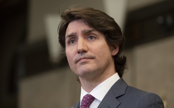 Prime Minister Justin Trudeau listens to a question from a reporter after announcing the Emergencies Act will be invoked to deal with protests on Monday, Feb. 14, 2022 in Ottawa. Trudeau says he has i ...
