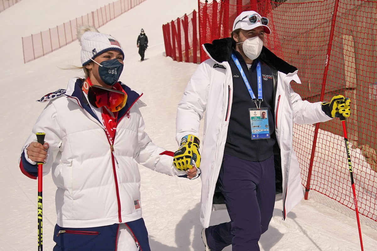 Norway's Aleksander Aamodt Kilde, right, and his girlfriend Mikaela Shiffrin, of United States stands leave the finish area after she competed in the women's super-G at the 2022 Winter Olymp ...