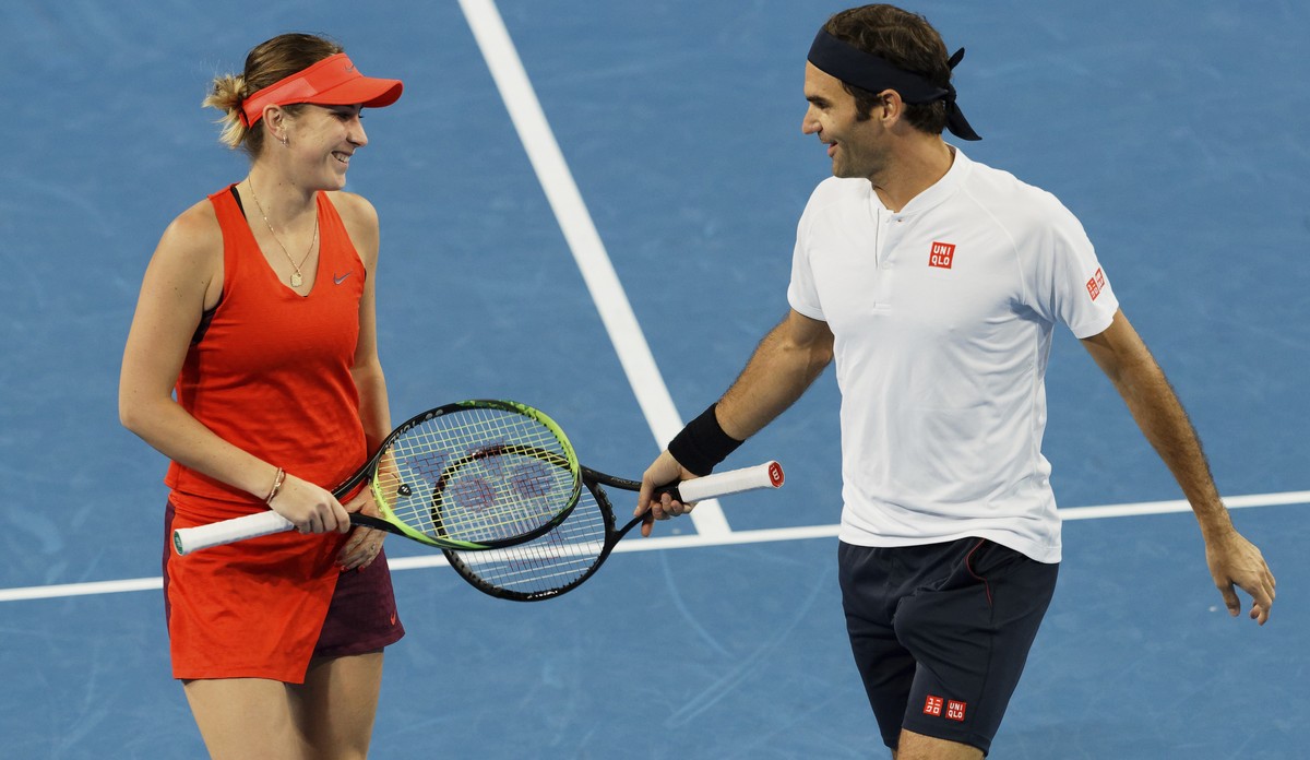 Switzerland's Roger Federer and Belinda Bencic share a laugh during their mixed doubles match against Stefanos Tsitsipas and Maria Sakkari of Greece at the Hopman Cup in Perth, Australia, Thursda ...