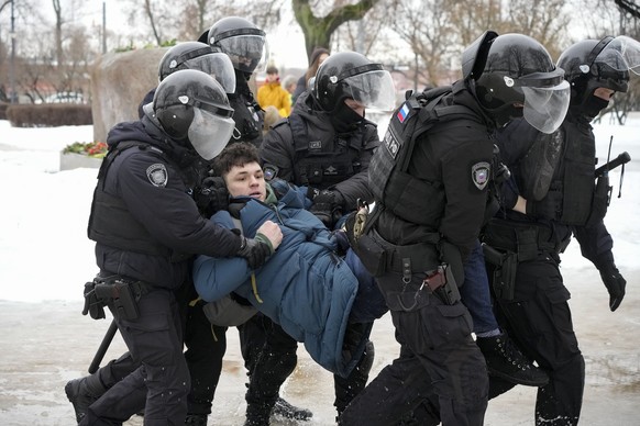 Police detain a man as he wanted to lay flowers paying their last respect to Alexei Navalny at the monument, a large boulder from the Solovetsky islands, where the first camp of the Gulag political pr ...