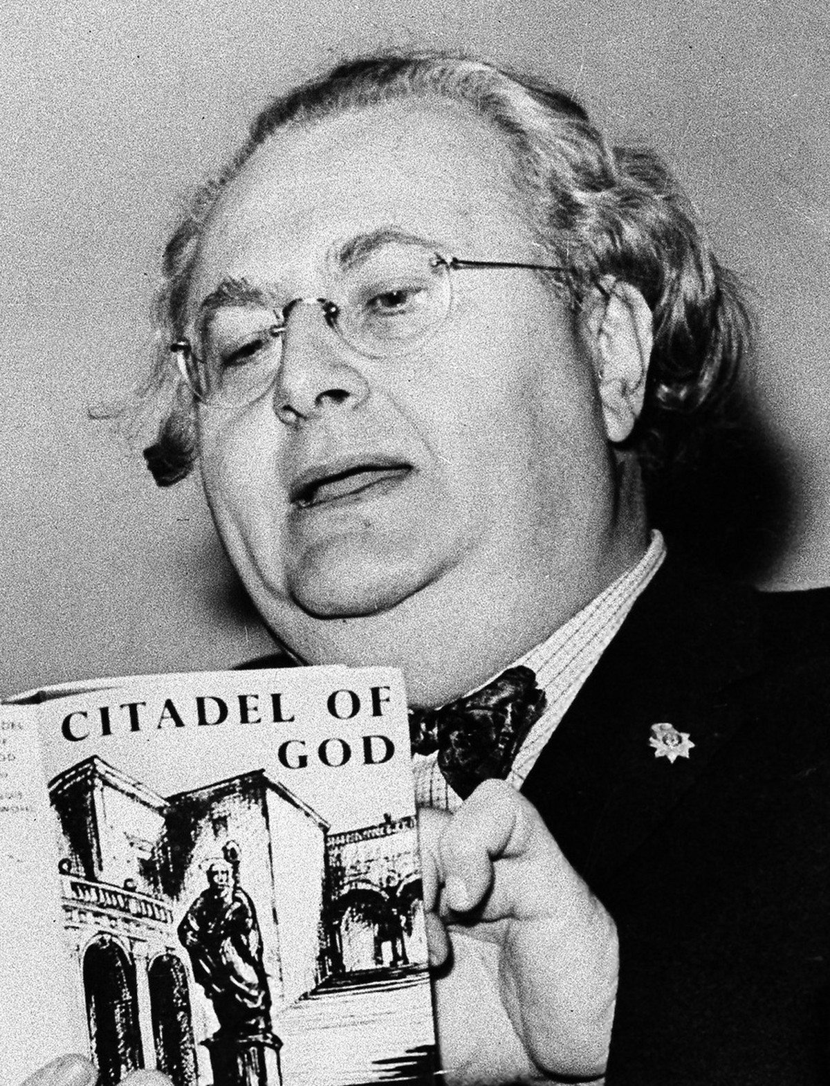 ** FILE ** Astrologer Louis De Wohl looks at a copy of his book "The Citadel of God" in this March 21, 1960 file pictrue taken in London. Desperate for a glimpse into Adolf Hitler's unp ...