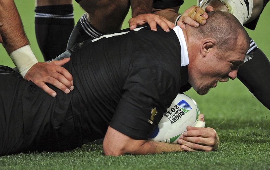 New Zealand All Blacks Tony Woodcock is congratulated after scoring a try during their Rugby World Cup final against France in Auckland, New Zealand, Sunday, Oct. 23, 2011. (AP Photo/Ross Land)