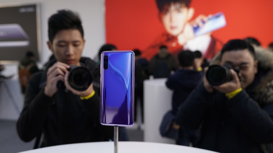 epa07382413 A visitor takes photos of the Xiaomi &#039;Mi 9&#039; mobile phone during the Xiaomi product launch ceremony in Beijing, China, 20 February 2019. Xiaomi releases its new mobile phone produ ...