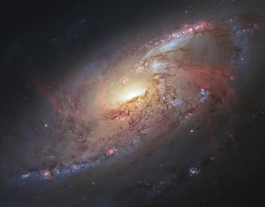 FILE - This file image made by the NASA/ESA Hubble Space Telescope shows M106 with additional information captured by amateur astronomers. Despite years of legal battles and months of protests by Nati ...