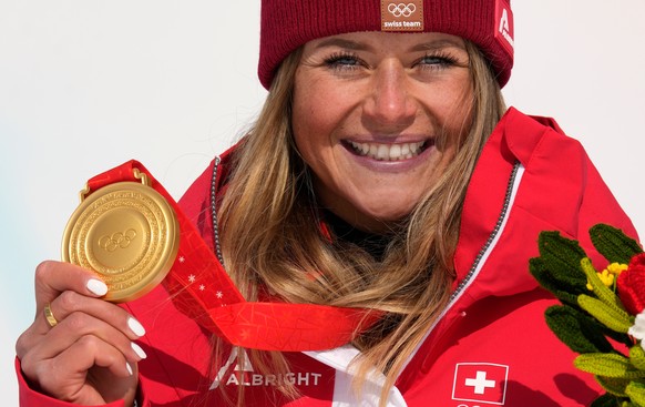 FILE - Switzerland&#039;s Corinne Suter poses during the medal ceremony for women&#039;s downhill at the 2022 Winter Olympics, Feb. 15, 2022, in the Yanqing district of Beijing. (AP Photo/Luca Bruno,  ...
