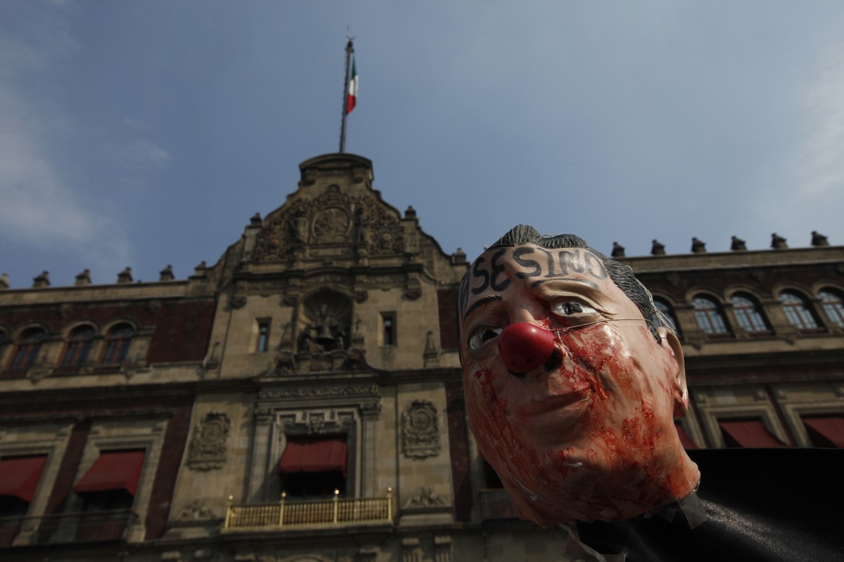 Protesters demonstrate with an effigy of President Enrique Pena Nieto, against fuel price hikes outside the national palace in Mexico City, Saturday, Jan. 7, 2017. The effigy has the word "Assass ...