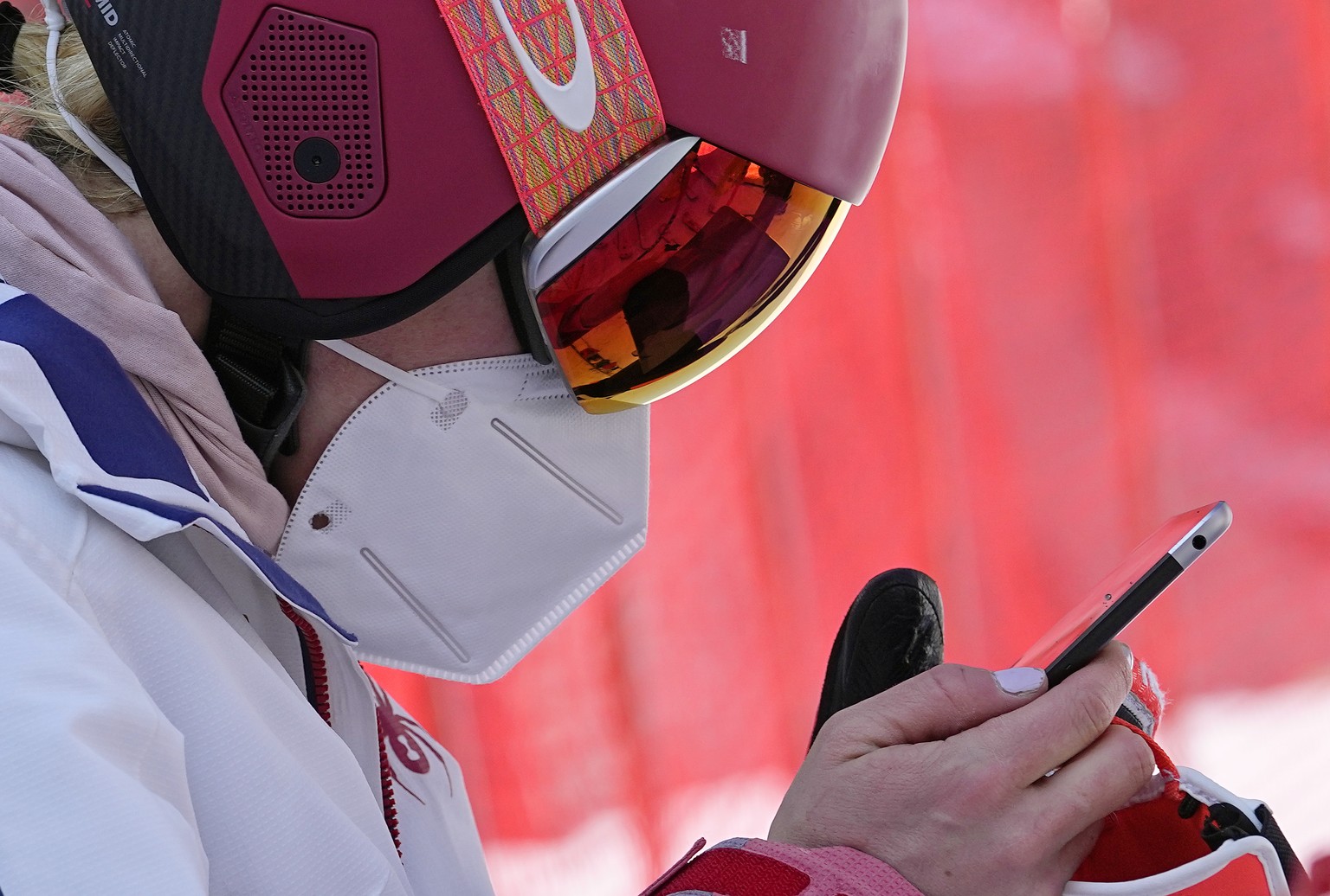 Mikaela Shiffrin of the United States looks at a tablet before heading to the gondola to go up the alpine ski course for a training run at the 2022 Winter Olympics, Thursday, Feb. 10, 2022, in the Yan ...