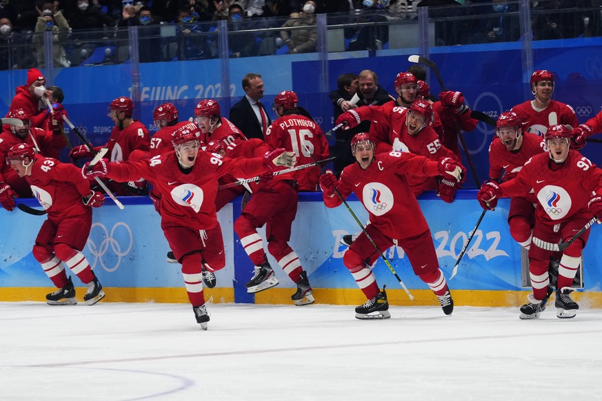 The Russian Olympic Committee celebrates the winning goal by Arseni Gritsyuk during a shootout in a men&#039;s semifinal hockey game against Sweden at the 2022 Winter Olympics, Friday, Feb. 18, 2022,  ...