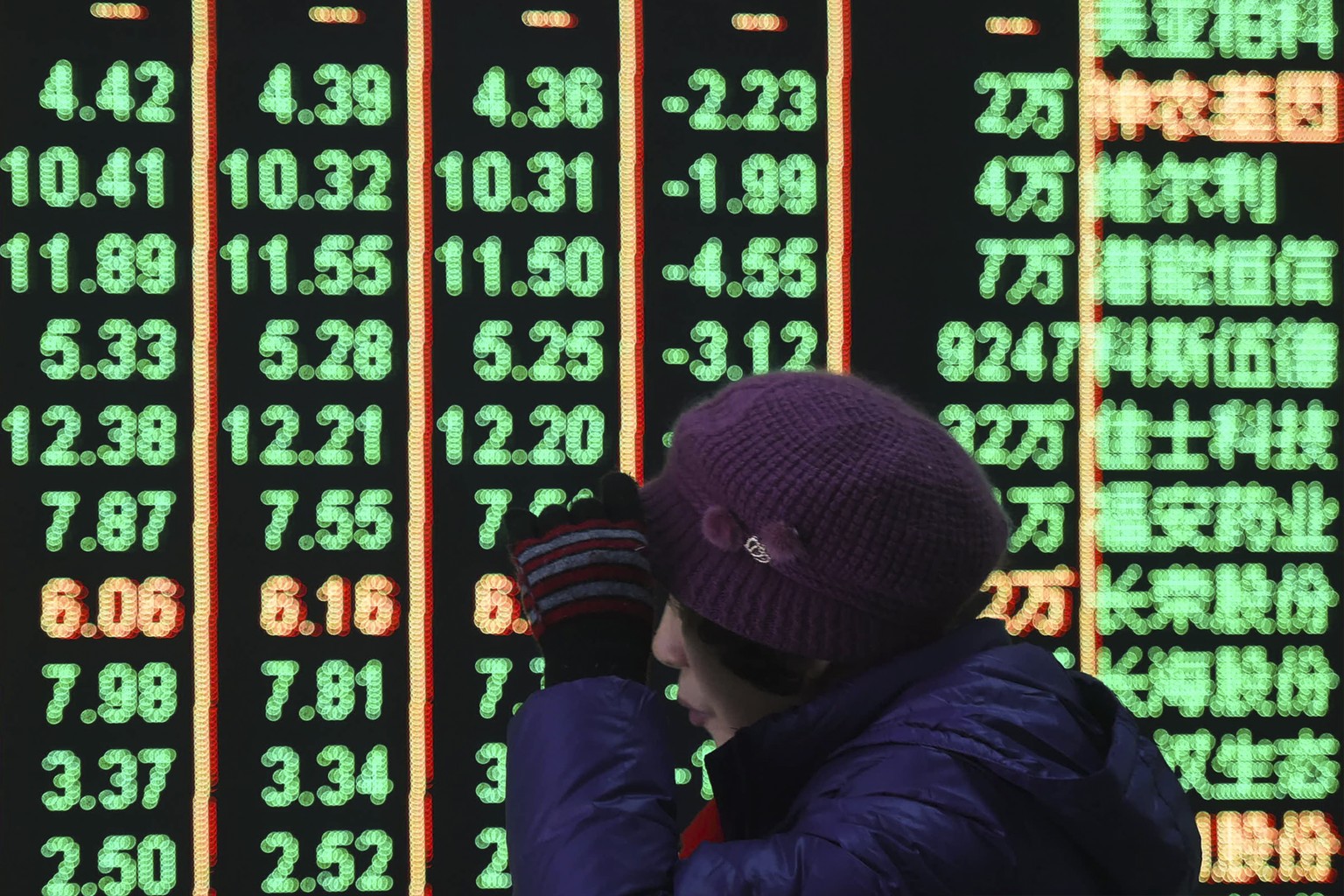 FILE - A woman reacts in front of an electronic screen displaying stock prices at a brokerage house in Hangzhou in east China&#039;s Zhejiang province, on Feb. 5, 2024. Chinese shares rallied on Frida ...