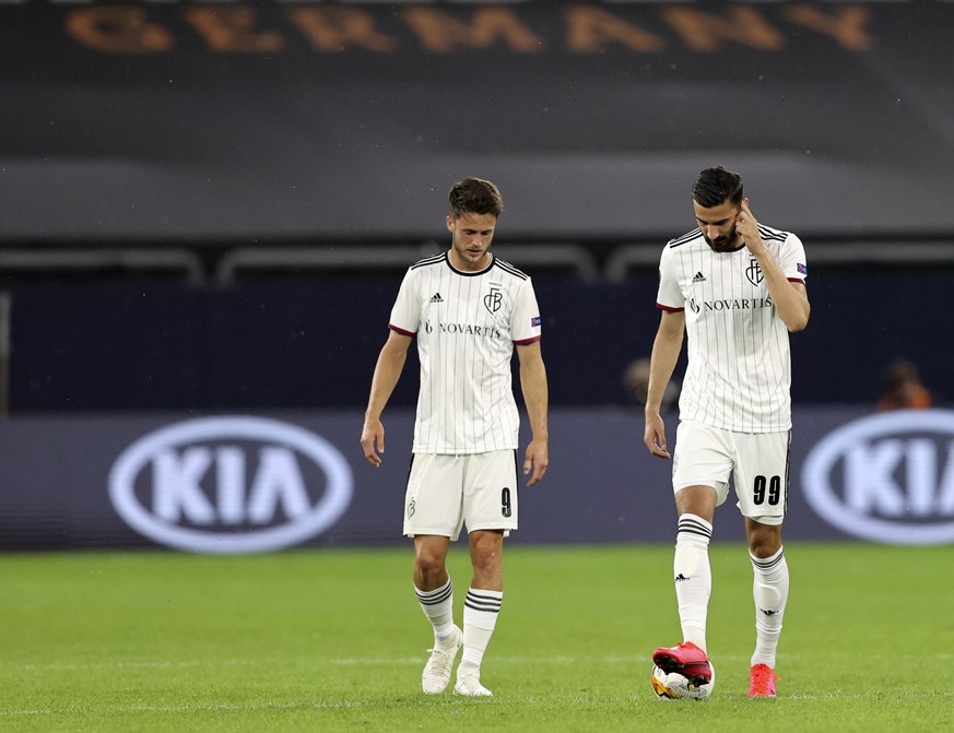 FC Basel&#039;s Ricky van Wolfswinkel, left, and FC Basel&#039;s Kemal Ademi react after Shakhtar&#039;s Dodo scores his side&#039;s fourth goal during the Europa League quarter finals soccer match be ...