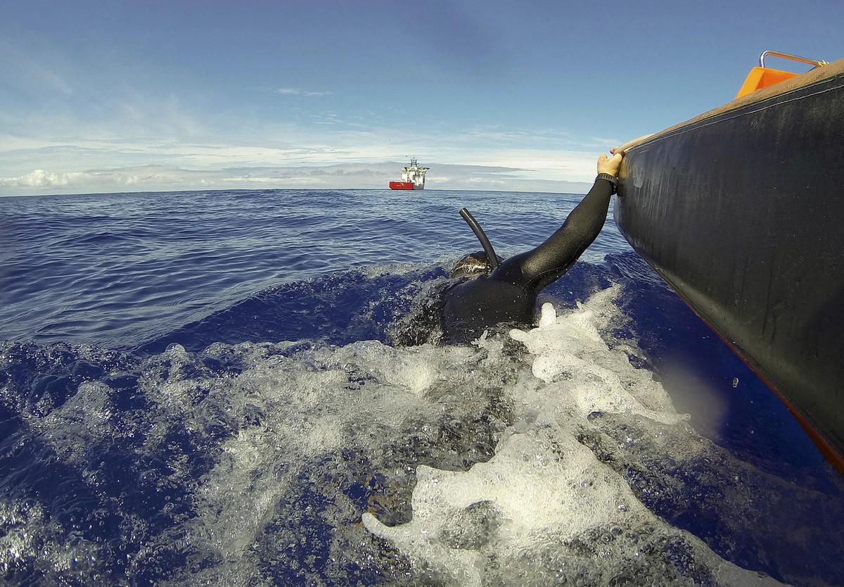 In this April 7, 2014 photo provided by the Australian Defense Force Able Seaman Clearance Diver Michael Arnold is towed by a fast response craft from the Australian Defense's ship Ocean Shield a ...