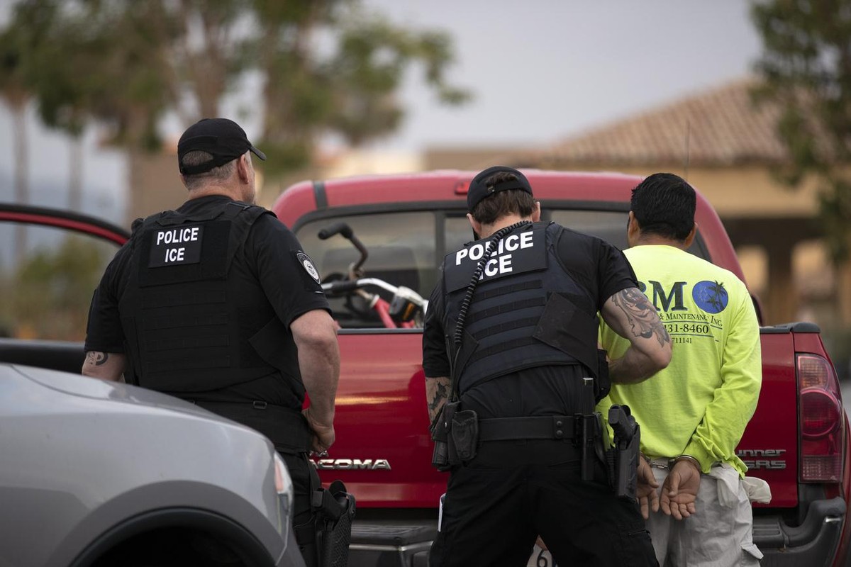 FILE - In this July 8, 2019, file photo, U.S. Immigration and Customs Enforcement (ICE) officers detain a man during an operation in Escondido, Calif. During the Trump administration's final week ...