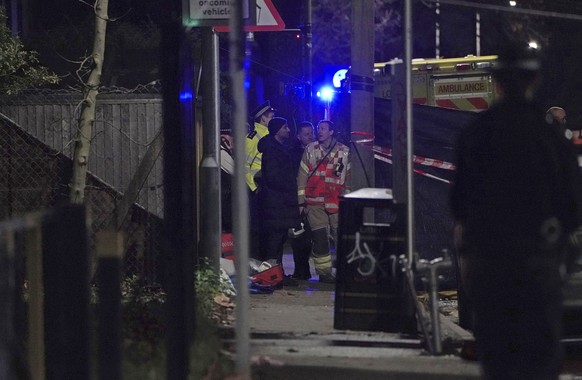 Firefighters work at the scene in Sutton, south London, where four children have died following a fire at a house, Thursday, Dec. 16, 2021. The London Fire Brigade (LFB) said eight fire engines and ar ...