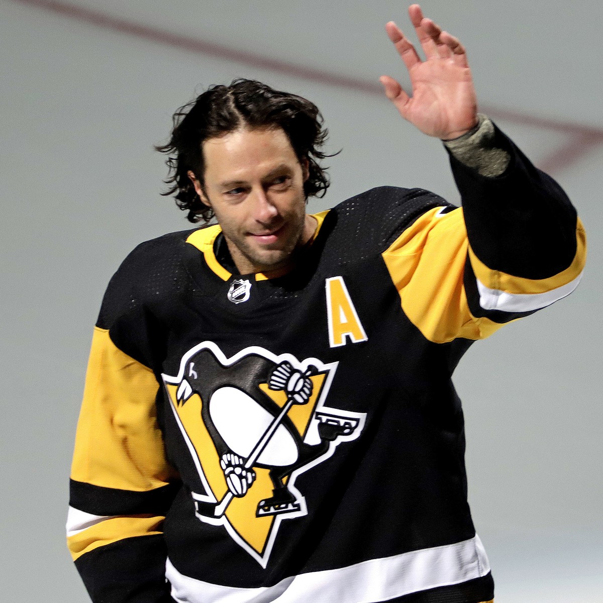 Pittsburgh Penguins' Matt Cullen waves to fans during a pregame celebration of his 1,500th career NHL hockey game against the Florida Panthers in Pittsburgh, Tuesday, March 5, 2019. Cullen joins  ...