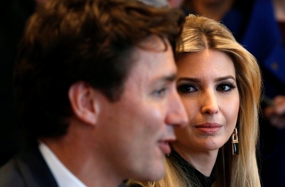 Ivanka Trump looks at Canadian Prime Minister Justin Trudeau (L) during U.S. President Donald Trump&#039;s roundtable discussion on the advancement of women entrepreneurs and business leaders at the W ...