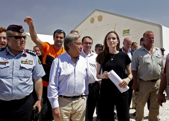 FILE - In this June 20, 2013 file photo, U.N. refugee chief, Antonio Guterres, second left, along with UNHCR special envoy, actress Angelina Jolie, second right, visit Zaatari refugee camp, near the S ...
