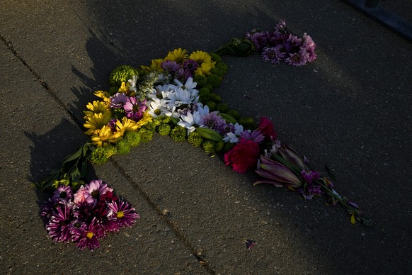 Flowers in the shape of a uterus made by Krissy Shields is seen by the steps of the Supreme Court on Friday, April 21, 2023, in Washington after the court decided to preserve women&#039;s access to a  ...