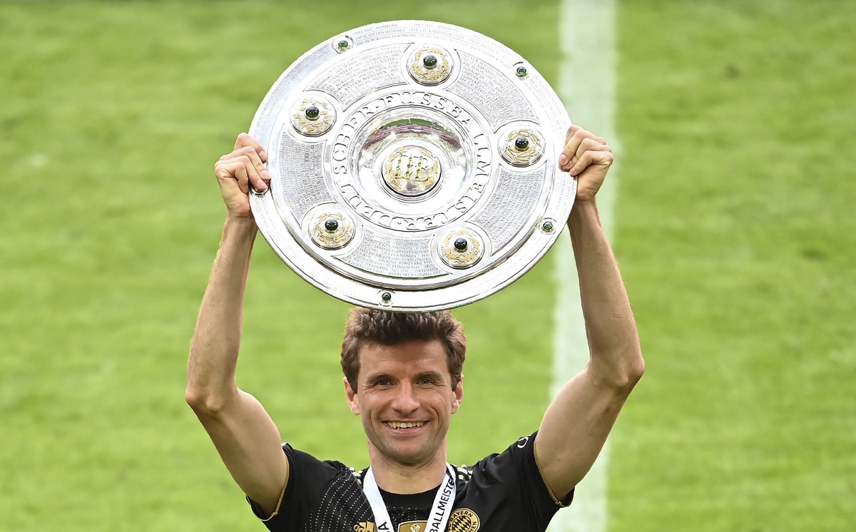 Bayern's Thomas Mueller holds a trophy of the best scorer of the season after winning the Bundesliga title after the German Bundesliga soccer match between Bayern Munich and FC Augsburg at the Al ...