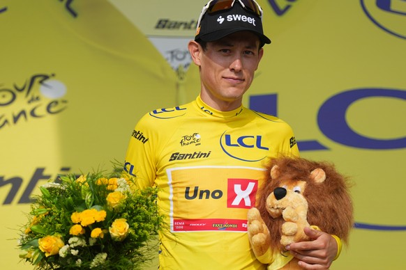 Norway's Torstein Traeen wearing the overall leader's yellow jersey celebrates on the podium after the fifth stage of the Tour de France cycling race with start in Lannemezan and finish in P ...