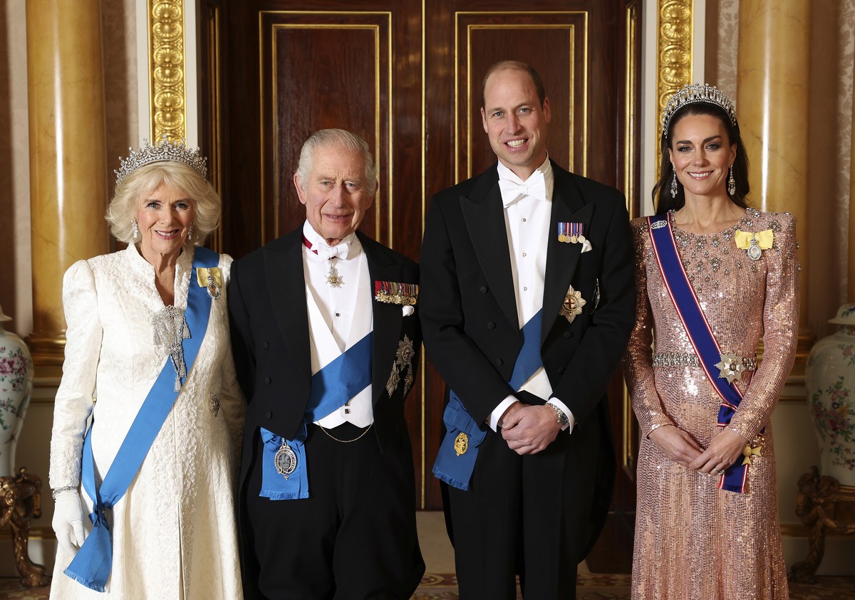 Britain's Queen Camilla, King Charles III, Prince William and Kate, Princess of Wales pose for a photograph ahead of the Diplomatic Reception in the 1844 Room at Buckingham Palace in London, Engl ...