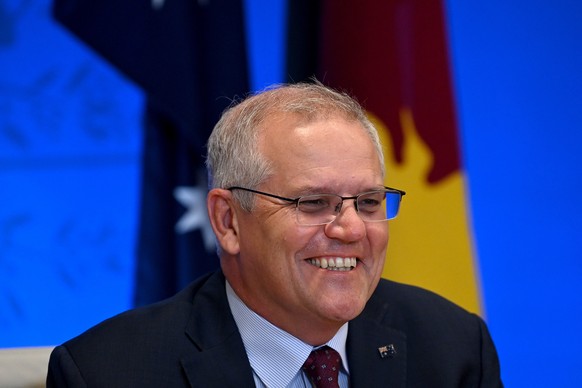 epa09698988 Australian Prime Minister Scott Morrison is seen during the Australia-Papua New Guinea Ports Infrastructure Investment Program Virtual Signing Ceremony at the Commonwealth Parliamentary Of ...