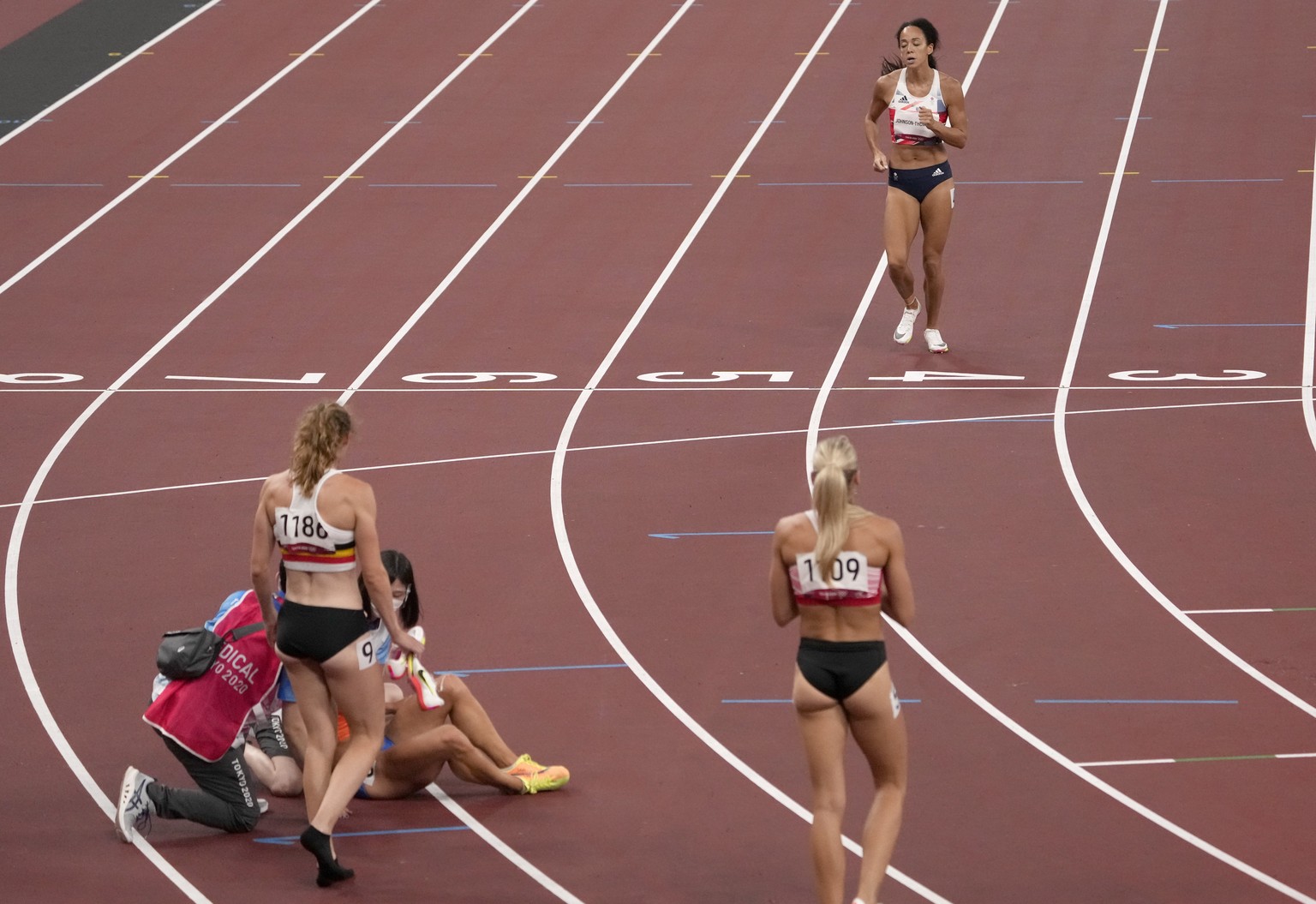 Katarina Johnson-Thompson, of Britain ambles across the line after pulling up injured in the heptathlon 200-meters at the 2020 Summer Olympics, Wednesday, Aug. 4, 2021, in Tokyo, Japan. (AP Photo/Char ...