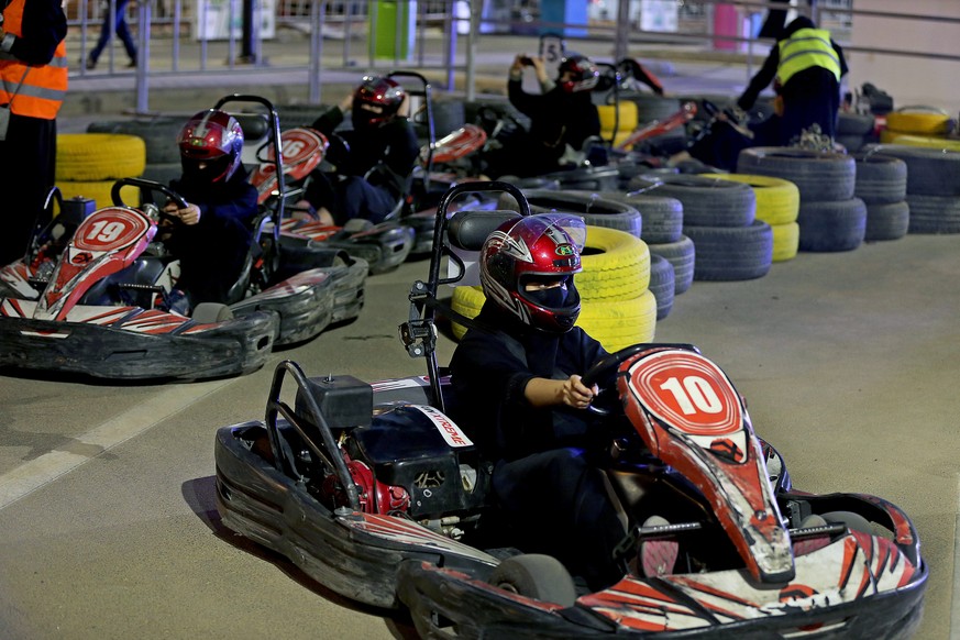 epa06834872 Saudi women drive go-karts at an outdoor educational driving event at Riyadh Park Mall in Riyadh, Saudi Arabia, 23 June 2018. Saudi women will be allowed to drive in the country as a contr ...