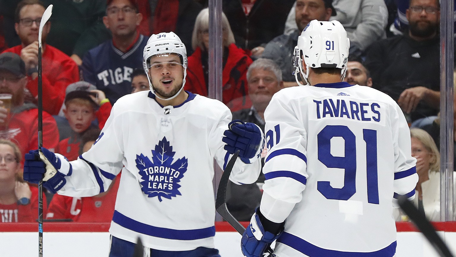 Toronto Maple Leafs center Auston Matthews, left, celebrates his goal with John Tavares (91) during the third period of an NHL hockey game against the Detroit Red Wings, Thursday, Oct. 11, 2018, in De ...