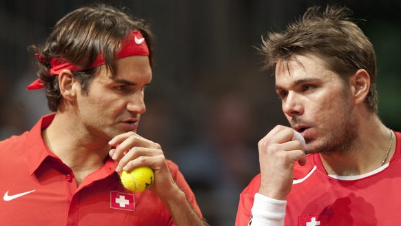 Swiss Davis Cup tennis player Stanislas Wawrinka, right, and teammate Roger Federer, left, react after loosing a point against US Davis Cup tennis player Mardy Fish and Mike Bryan during the Davis Cup ...